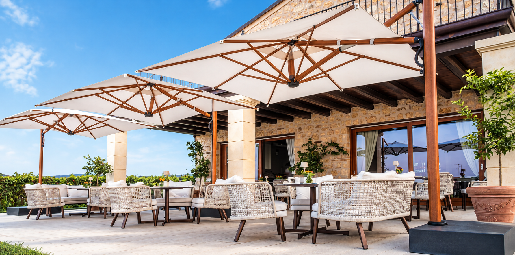 Square cantilever umbrellas shading a luxury stone patio lounge