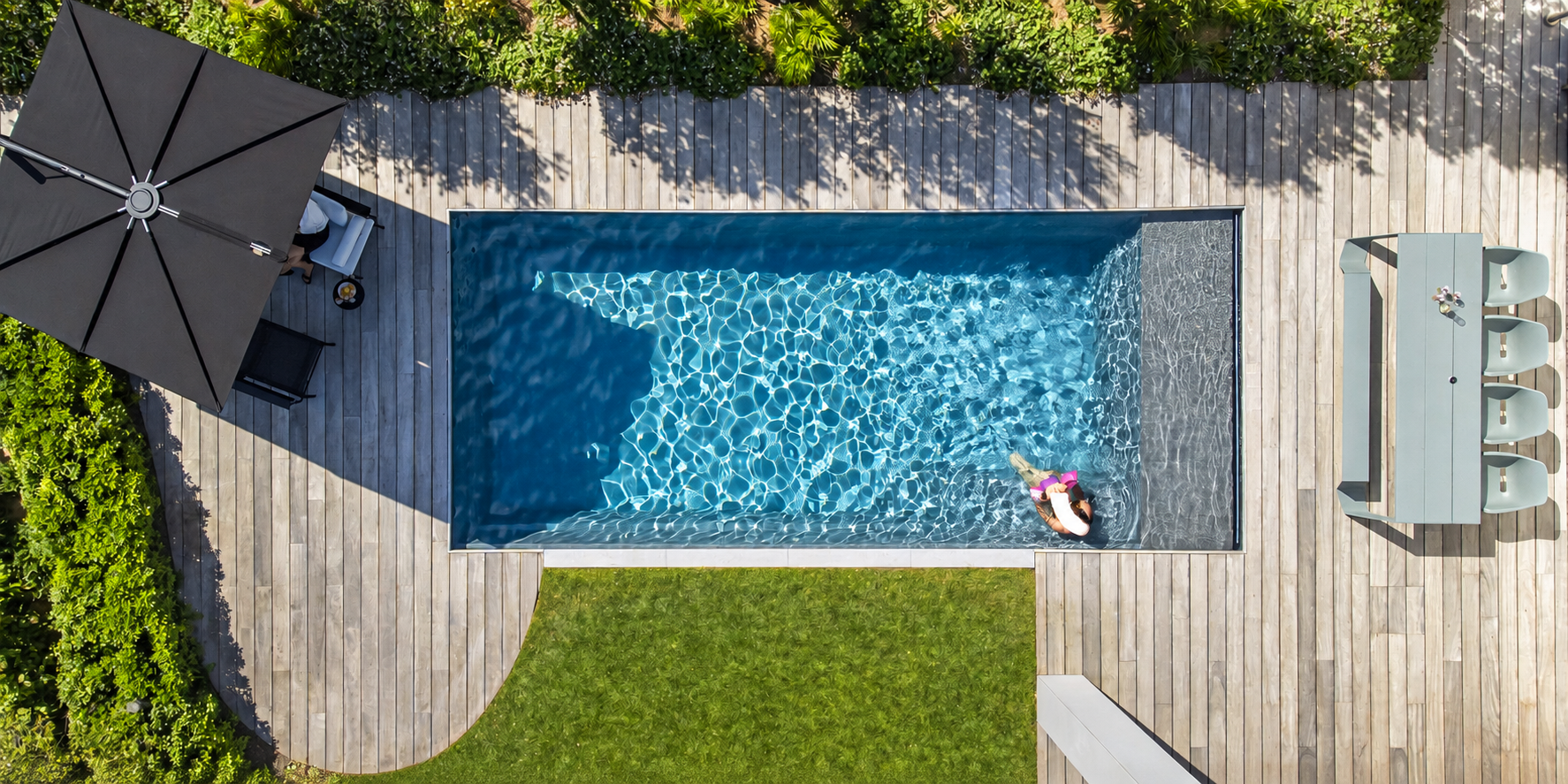 Aerial view of a cantilever umbrella beside a modern pool deck